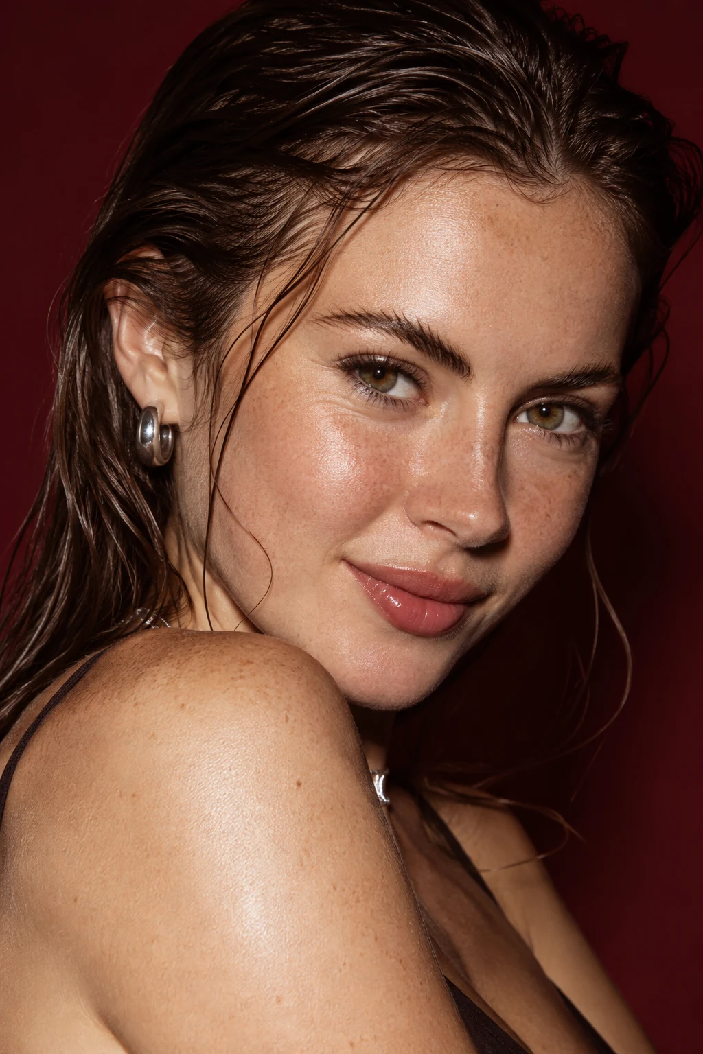 Conceptual young adult beauty portrait with freckles, silver jewelry and natural skin texture